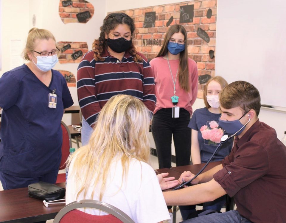 Photo of Patient Care Technician students practicing skills.